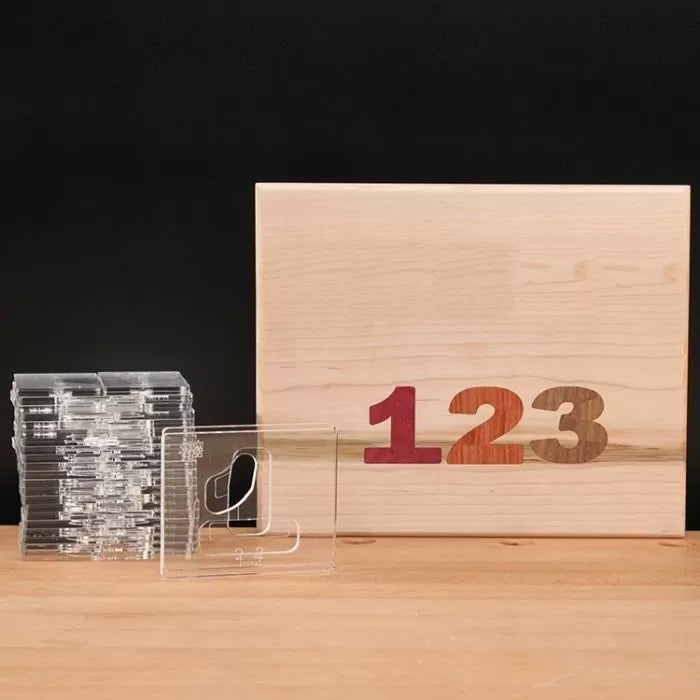Woodworking template set and wood panel with inlaid numbers 1 2 3, on wood table