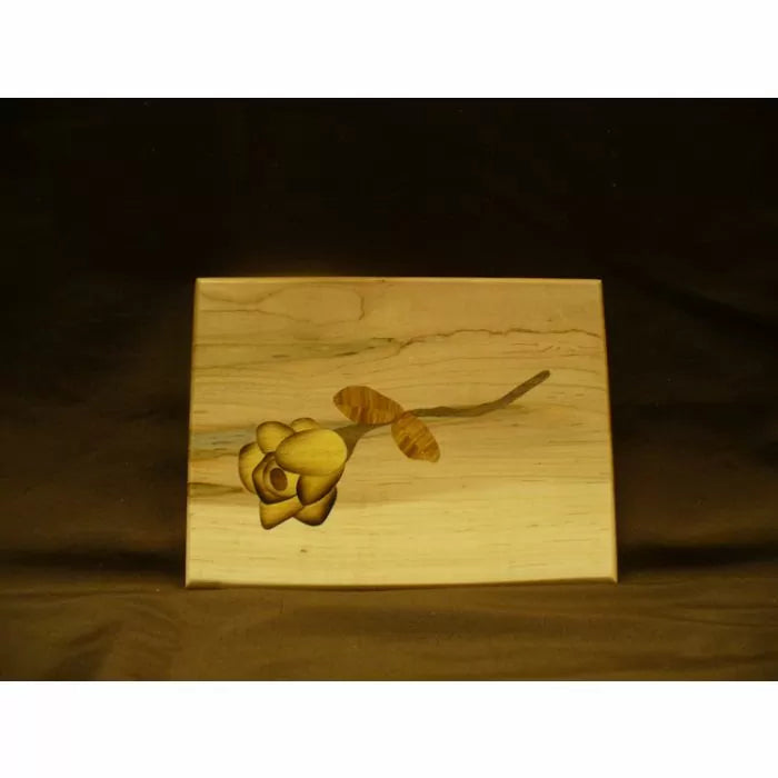 Wooden keepsake box with yellow flower inlay, woodworking project on light wood background