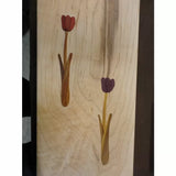 Wood inlay panel with two floral tulip designs on a light wood background