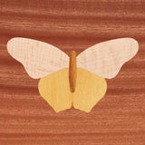 Butterfly wood inlay on a polished wooden surface, woodworking marquetry detail