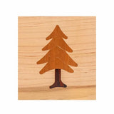 Wood inlay of a pine tree design on a light wood background, ideal for woodworking projects.