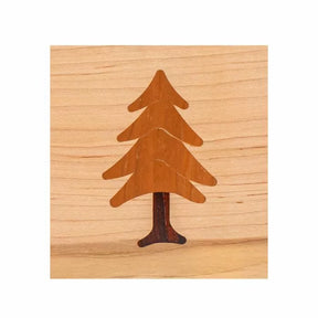 Wood inlay of a pine tree design on a light wood background, ideal for woodworking projects.
