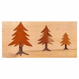 Wood inlay project with three tree silhouettes on light wood background, woodworking example