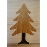 Wood inlay of a pine tree on a light wood surface, woodworking project detail