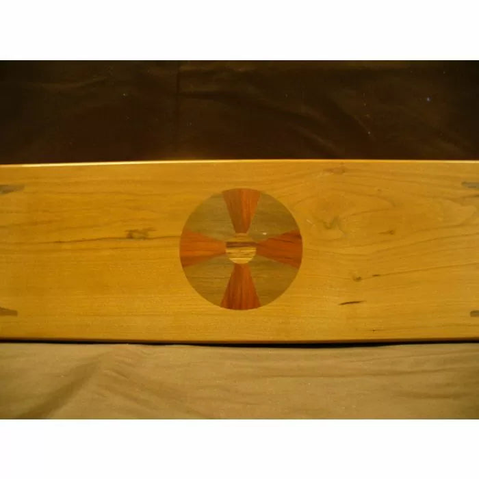 Wood board with inlaid circular geometric pattern, ideal for woodworking projects