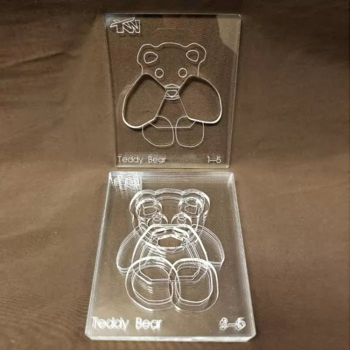 Clear acrylic teddy bear woodworking templates for precise cutting on brown background