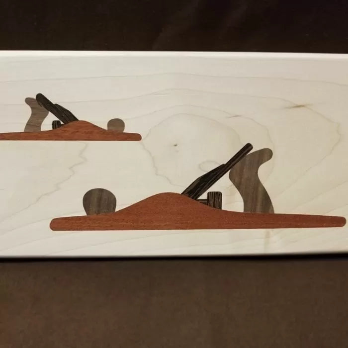 Wood inlay art of two hand planes on light wood background for woodworking decor