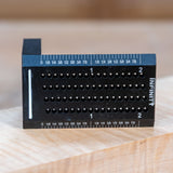 Black aluminum woodworking saddle square with drill guide holes and etched ruler markings