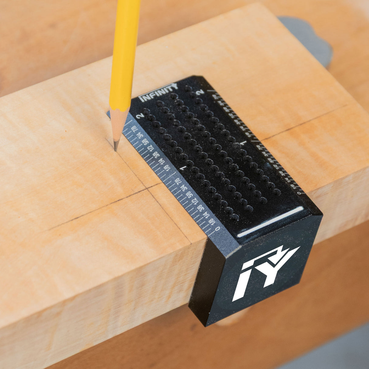 Saddle square woodworking tool marking lines on wood with pencil, measurement guide visible