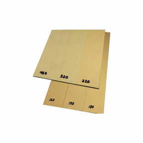 Assorted sandpaper sheets with labeled grits 120, 150, 180, 220, 320, and 400 for woodworking