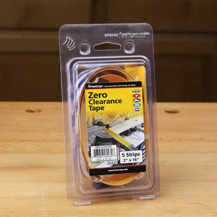 Zero clearance tape package for woodworking on wooden workbench, includes five strips.