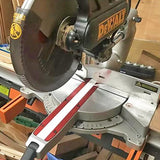 Miter saw with measuring fence attachment in a woodworking workshop setting