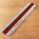 Aluminum table saw zero clearance insert plate with red center strip on a wooden surface