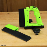 Green woodworking push block tool with detachable guide on a wood workbench