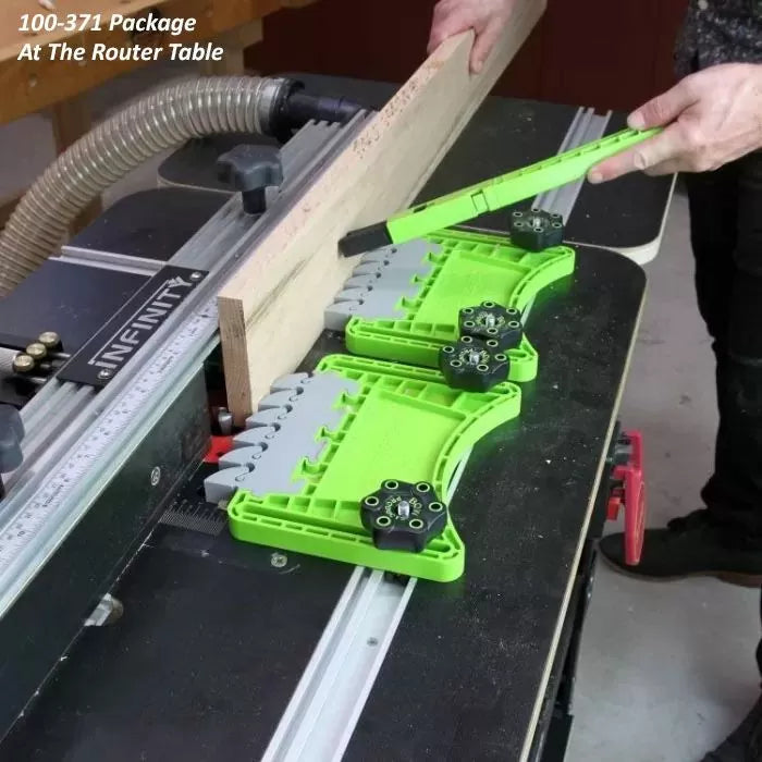 Green featherboards securing wood on a router table for precise woodworking.