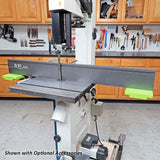 Band saw with adjustable fence and safety accessories in woodworking shop
