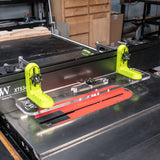 L-fence system for table saw with bright green brackets and clear acrylic base on a woodworking tool.