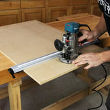 Woodworker using a router and guide rail to cut MDF board on a workbench