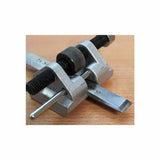 Woodworking honing guide tool on a wooden surface for sharpening chisels and blades