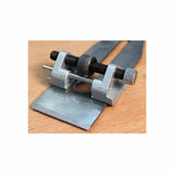 Honing guide jig for sharpening woodworking plane blades on a wooden surface