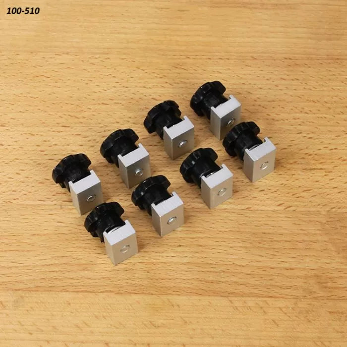 Eight aluminum T-track knobs with black handles for woodworking jigs on a wooden surface