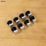 Eight aluminum T-track knobs with black handles for woodworking jigs on a wooden surface