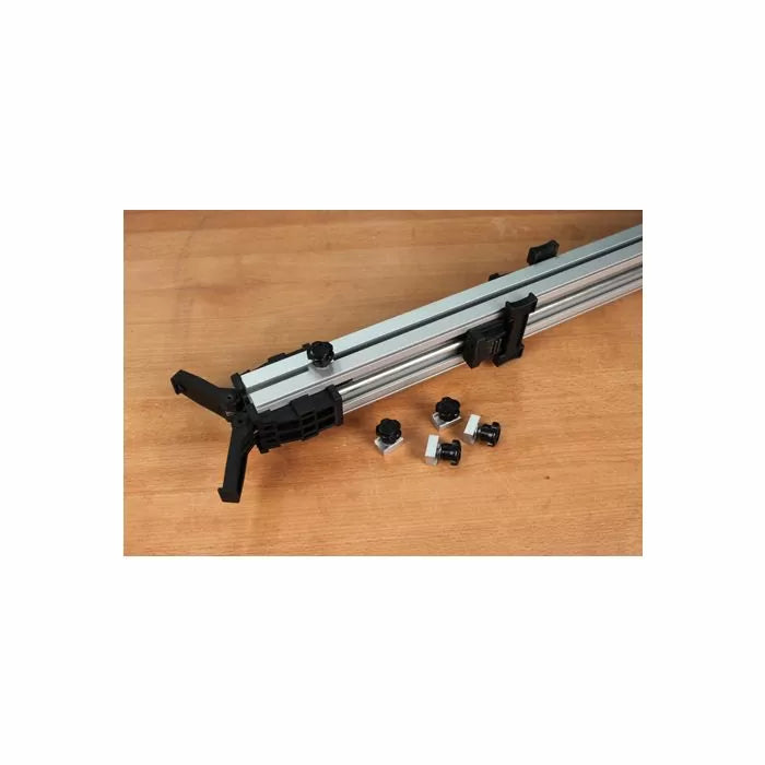 Aluminum woodworking track fence with adjustment knobs and mounting hardware on a wood surface