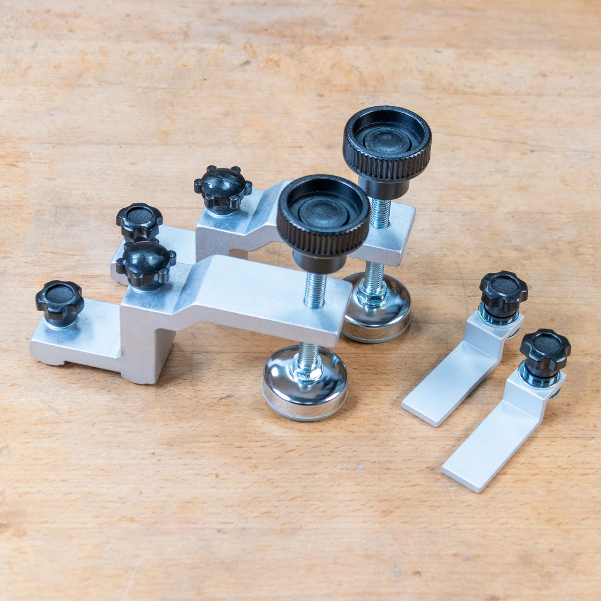 Pro-Grip Hold Down Kit components on a wooden benchtop.