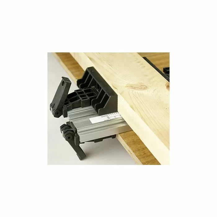 Woodworking clamp jig securing a wooden board to a workbench for precise cutting.