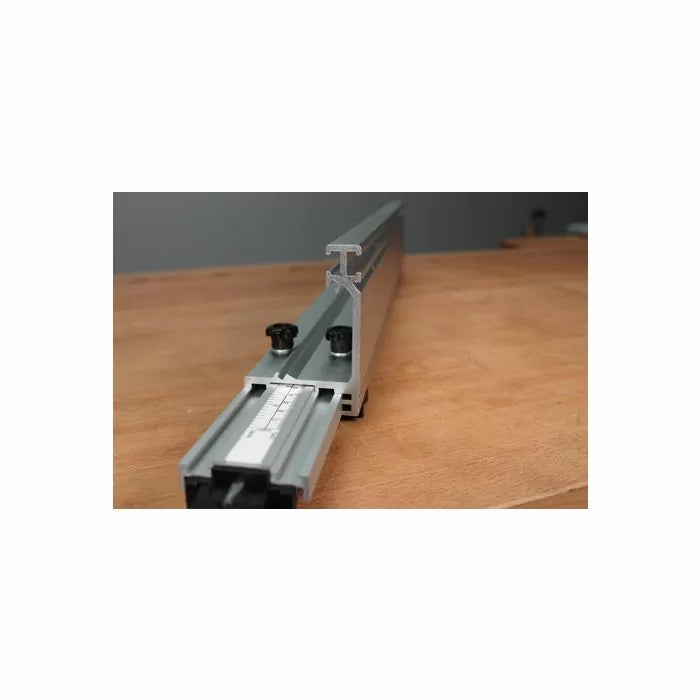 Aluminum router table fence with measurement scale on a wooden workbench surface