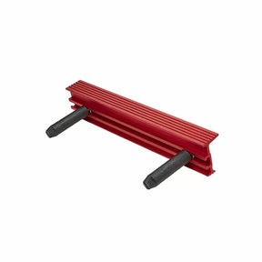 Red woodworking featherboard with grooved surface and two black adjustment knobs