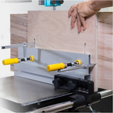 Woodworker using a bandsaw fence jig with yellow handles to cut precise grooves in wood