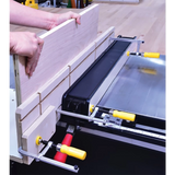 Woodworker using dado sled jig and clamps on table saw for precise woodworking cuts