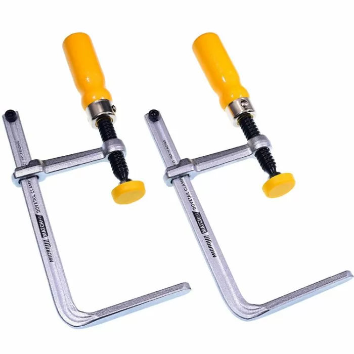 Pair of metal woodworking clamps with yellow handles on white background