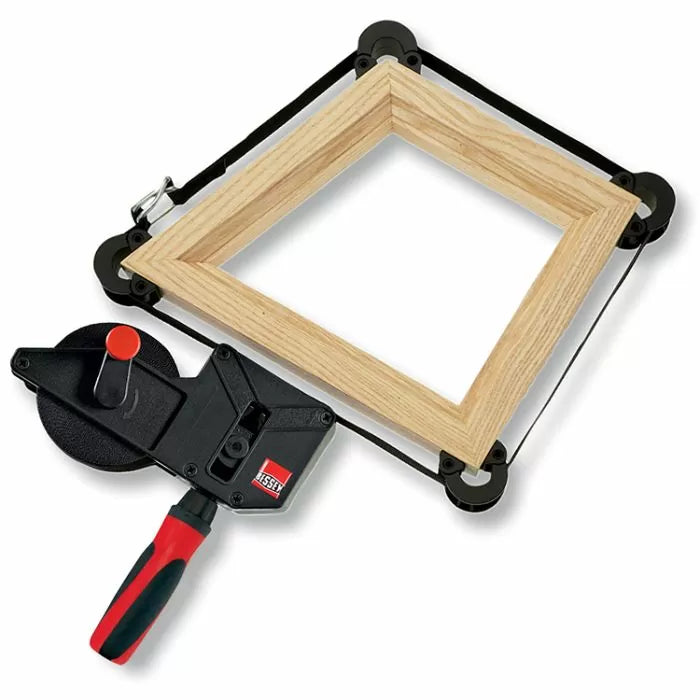 Corner band clamp securing a wooden picture frame for precise woodworking assembly