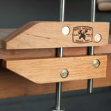 Woodworking hand screw clamp with metal bolts securing wooden jaws for precise clamping