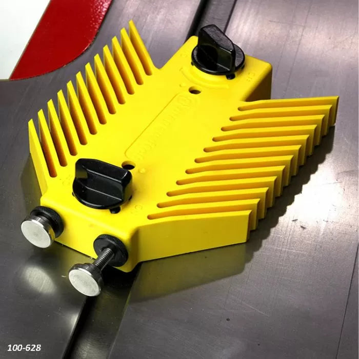 Yellow plastic featherboard for table saw with adjustment knobs on metal tabletop