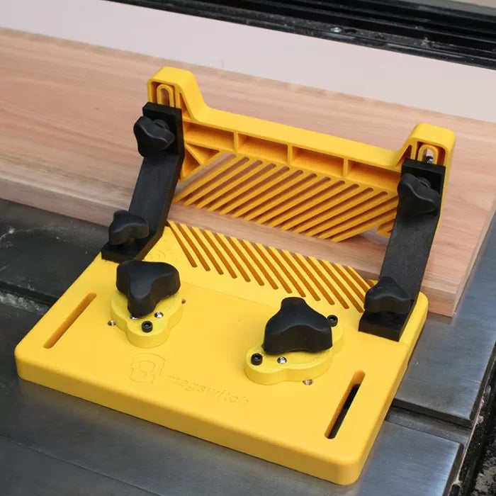 Table saw featherboard jig holding wood in place for precise woodworking cuts