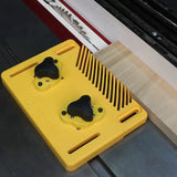 Yellow magnetic featherboard holding wood against table saw fence for woodworking safety