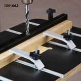 Drill press fence and clamps securing wood on a router table, woodworking tool setup