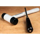 Woodworking mallet and chisel on a wooden workbench, precision hand tools for carpentry.