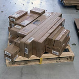 Stacked cardboard boxes of woodworking tools and accessories on a pallet in a warehouse
