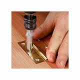 Self-centering drill bit used to install a brass hinge on a wooden surface for woodworking.