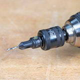 Close-up of drill with countersink bit attachment on wooden surface, woodworking tool accessory