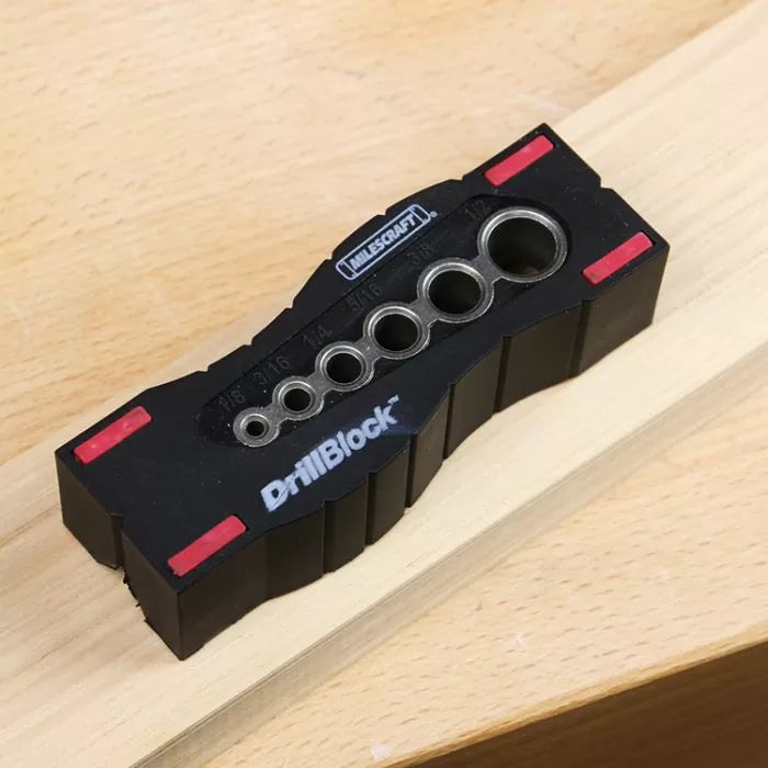 DrillBlock drill guide with multiple hole sizes on a wooden board, woodworking tool