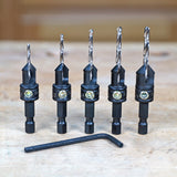 Set of five woodworking countersink drill bits with hex shanks and hex key on workbench