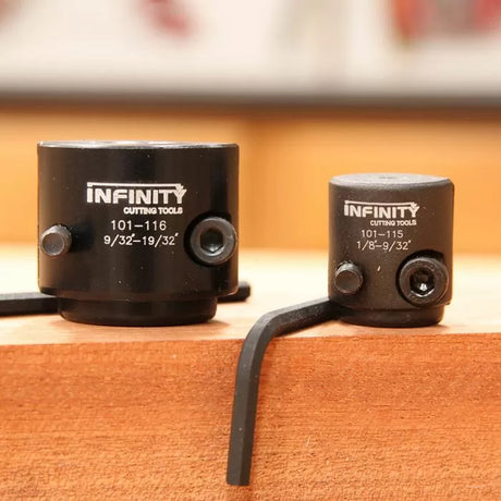 Two black woodworking depth stop collars with hex keys on a wooden workbench