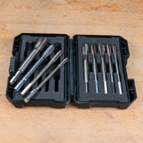 Metal tap and die set in black case on a wooden workbench, precision threading tools