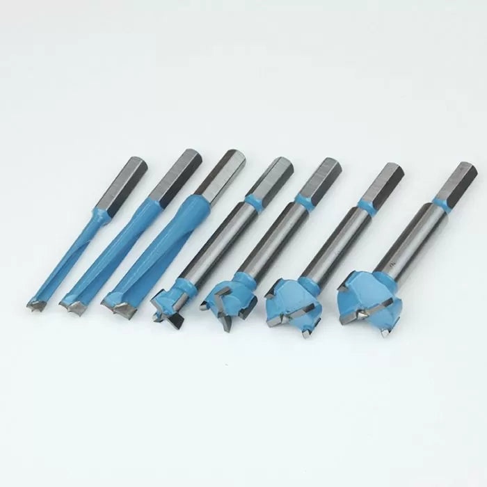 Set of seven blue and silver woodworking Forstner drill bits on a white background