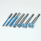 Set of seven blue and silver woodworking Forstner drill bits on a white background